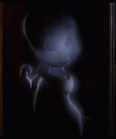 A Cartoon Ghost Is Standing In A Dark Room And Looking At The Camera GIF