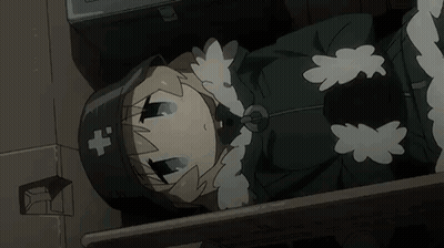 A Cartoon Girl Is Laying On The Floor In A Dark Room . She Is Wearing A Black Hat With A Cross On It . GIF