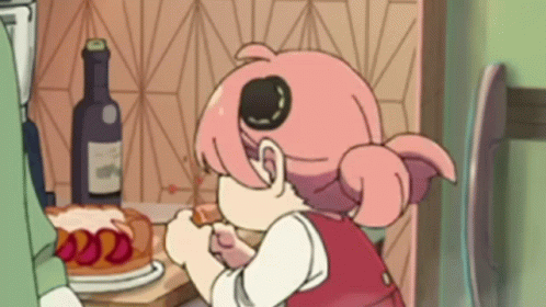A Cartoon Girl Is Sitting At A Table Eating A Cake . GIF