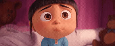 A Cartoon Girl Is Sitting On A Bed With A Brown Teddy Bear In The Background GIF