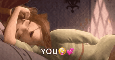 A Cartoon Girl Is Sleeping On A Bed With The Words `` You '' Written On It . GIF