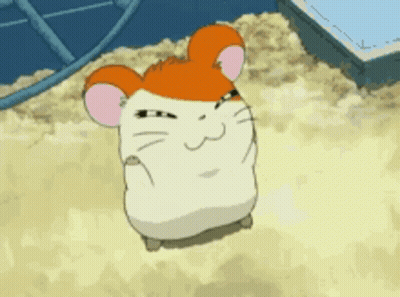 A Cartoon Hamster Is Sitting On A Pile Of Sand And Making A Face . GIF