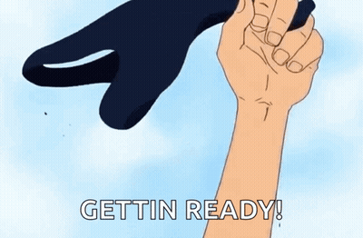 A Cartoon Hand Is Holding A Black Object With The Words Gettin Ready Written On It . GIF