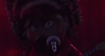 A Cartoon Hedgehog Is Singing Into A Microphone And Playing A Guitar GIF