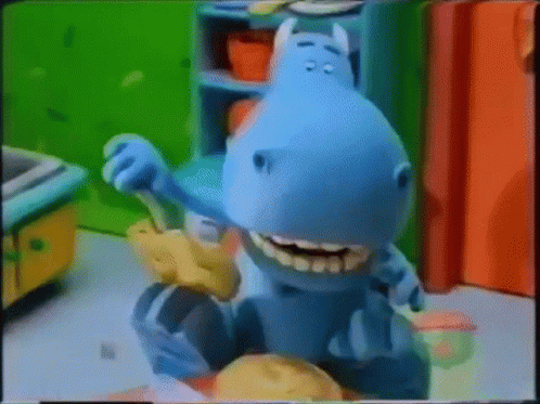 A Cartoon Hippo Is Brushing His Teeth In A Kitchen GIF