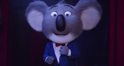 A Cartoon Koala Wearing A Blue Suit And A Bow Tie GIF