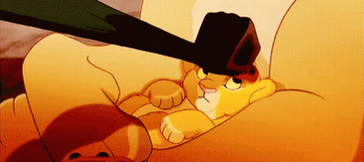 A Cartoon Lion Is Laying On A Couch With A Black Object On Its Head GIF