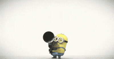 A Cartoon Minion Is Doing A Handstand With His Mouth Open And His Nose Sticking Out . GIF