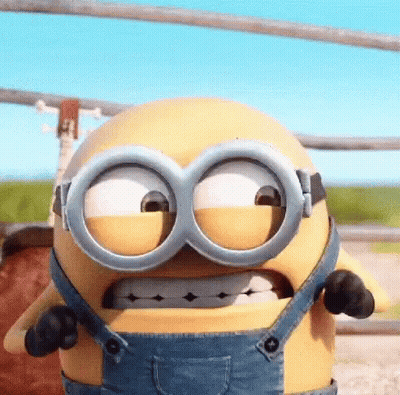 A Cartoon Minion Is Wearing Overalls And Goggles And Making A Funny Face . GIF
