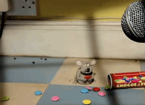 A Cartoon Mouse Is Eating Candy Next To A Can Of Chocola Chips GIF