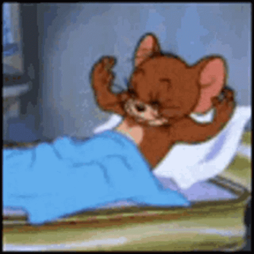 A Cartoon Mouse Is Laying In A Bed With A Blue Blanket GIF