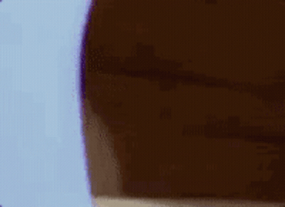 A Cartoon Mouse Is Peeking Out From Behind A Wall And Covering His Face . GIF