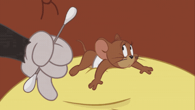 A Cartoon Mouse Laying On A Yellow Surface With A Hand Holding A Stick GIF