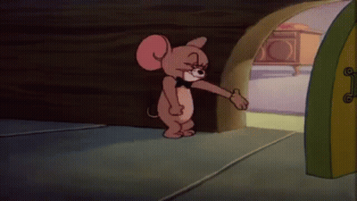 A Cartoon Mouse Wearing A Bow Tie Is Standing In Front Of A Door . GIF