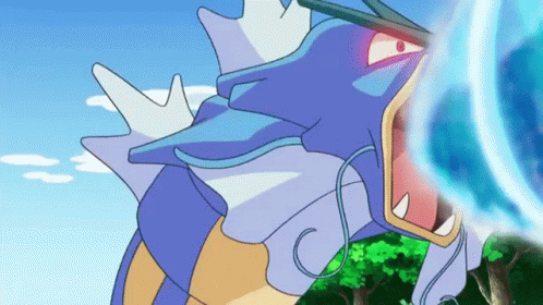 A Cartoon Of A Blue And Yellow Pokemon With Its Mouth Open And A Blue Light Coming Out Of It 'S Mouth . GIF