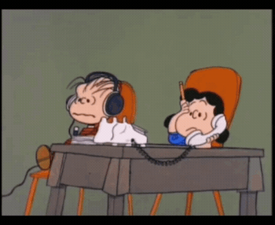 A Cartoon Of A Boy And A Girl Sitting At A Desk Talking On A Phone GIF