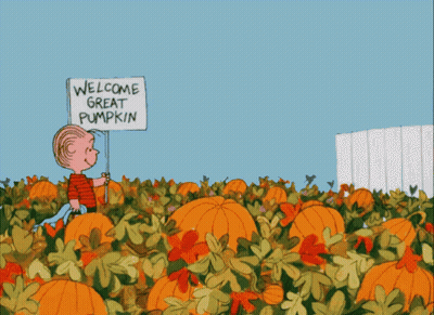 A Cartoon Of A Boy Holding A Sign That Says " Welcome Great Pumpkin " GIF