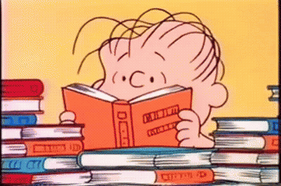A Cartoon Of A Boy Reading A Book In Front Of A Stack Of Books . GIF