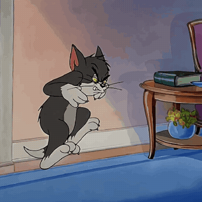 A Cartoon Of A Cat Standing Next To A Table With A Book On It GIF