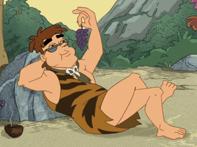 A Cartoon Of A Caveman Sitting On The Ground Holding A Grape GIF