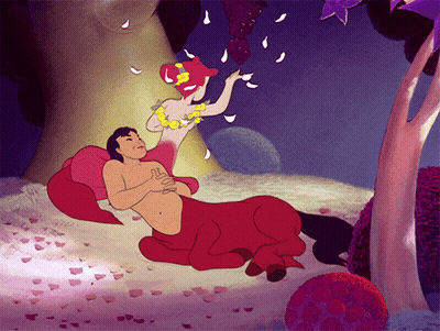 A Cartoon Of A Centaur And A Mermaid Laying On The Ground GIF