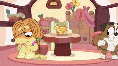 A Cartoon Of A Dog Sitting Next To A Table With A Sheep On It GIF