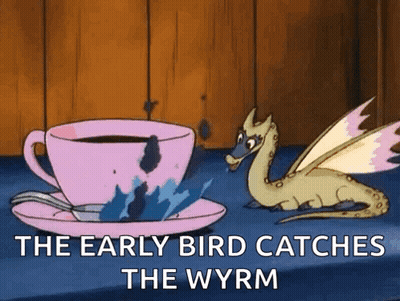A Cartoon Of A Dragon Sitting Next To A Cup Of Coffee GIF