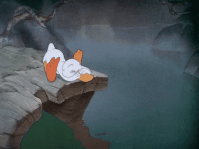 A Cartoon Of A Duck Laying On A Rock With The Words I 'M Written Above It GIF