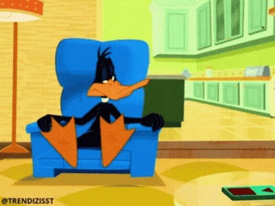 A Cartoon Of A Duck Sitting In A Chair GIF
