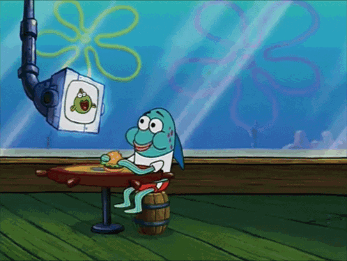 A Cartoon Of A Fish Sitting At A Table Eating A Burger GIF