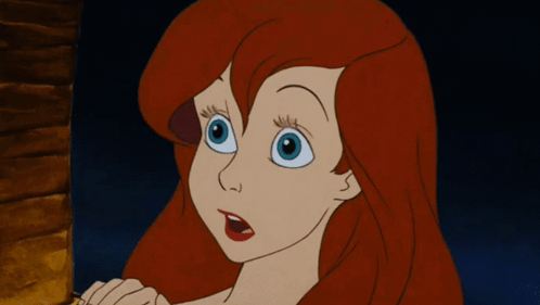 A Cartoon Of A Girl With Red Hair And Blue Eyes GIF