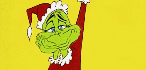A Cartoon Of A Grinch Wearing A Santa Hat And A Red Jacket . GIF