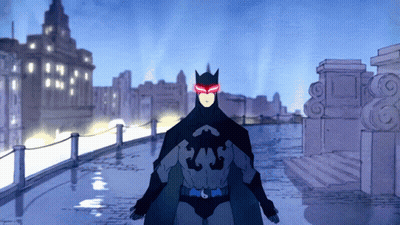 A Cartoon Of A Man In A Batman Costume With Red Eyes GIF