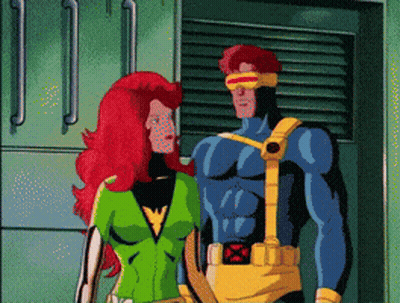 A Cartoon Of A Man In A Blue Suit And A Woman With Red Hair Standing Next To Each Other GIF