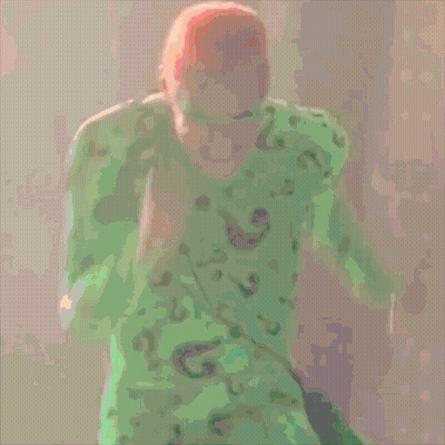 A Cartoon Of A Man In A Green Shirt And Green Mask GIF
