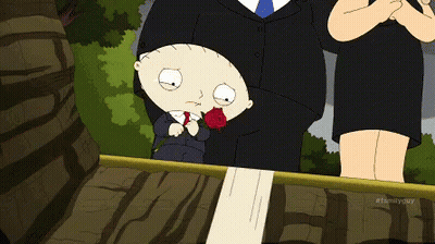 A Cartoon Of A Man In A Suit And Tie Standing Next To A Woman Holding A Rose GIF