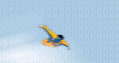 A Cartoon Of A Man In A Yellow And Blue Superhero Costume Flying Through The Air GIF