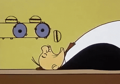 A Cartoon Of A Man Laying On A Table With His Head On A Table . GIF