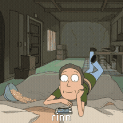 A Cartoon Of A Man Laying On The Floor Looking At A Phone GIF