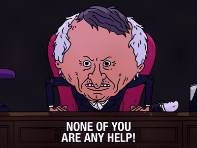 A Cartoon Of A Man Sitting At A Desk With The Words " None Of You Are Any Help " GIF