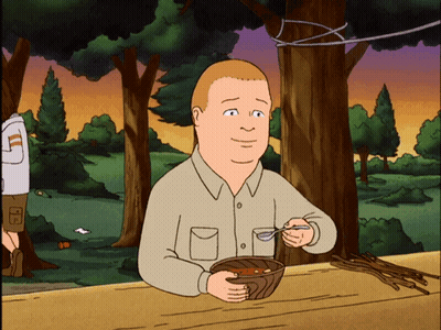 A Cartoon Of A Man Sitting At A Table Eating A Bowl Of Food GIF