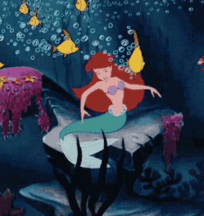 A Cartoon Of A Mermaid In The Ocean GIF
