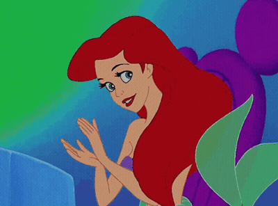 A Cartoon Of A Mermaid With Red Hair And Blue Eyes GIF