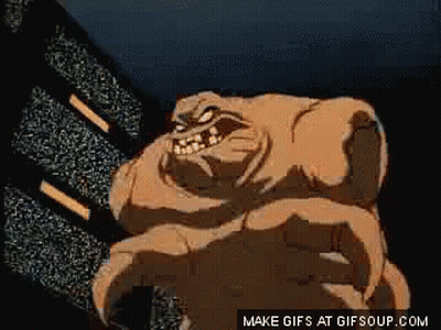 A Cartoon Of A Monster With Horns Standing In Front Of A Television Screen . GIF