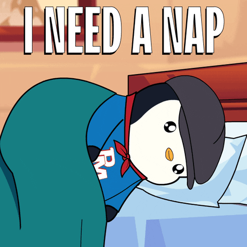 A Cartoon Of A Penguin Laying On A Bed With The Words I Need A Nap Below It GIF