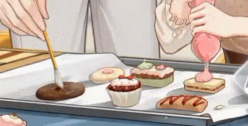 A Cartoon Of A Person Decorating Cupcakes On A Tray . GIF