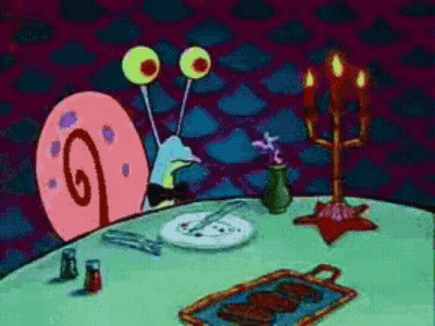 A Cartoon Of A Snail Sitting At A Table With A Plate Of Food On It GIF