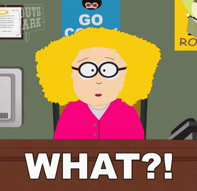 A Cartoon Of A Woman Sitting At A Desk With The Words " What ? " In Front Of Her GIF