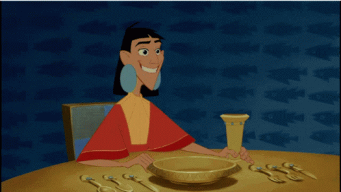 A Cartoon Of A Woman Sitting At A Table With A Bowl And Utensils GIF