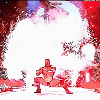 A Cartoon Of A Wrestler Standing In Front Of A Fireworks Display With The Letters W On The Bottom GIF